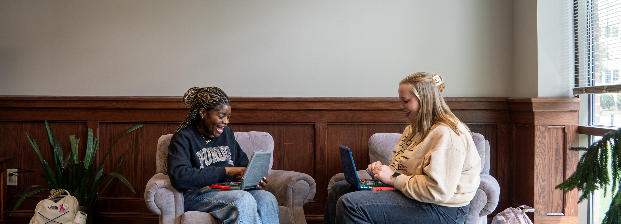 Two students playing a game with each other